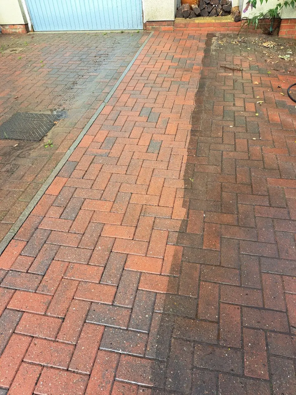 Block paved driveway and path part-cleaned, with a visible contrast between the clean and uncleaned paving